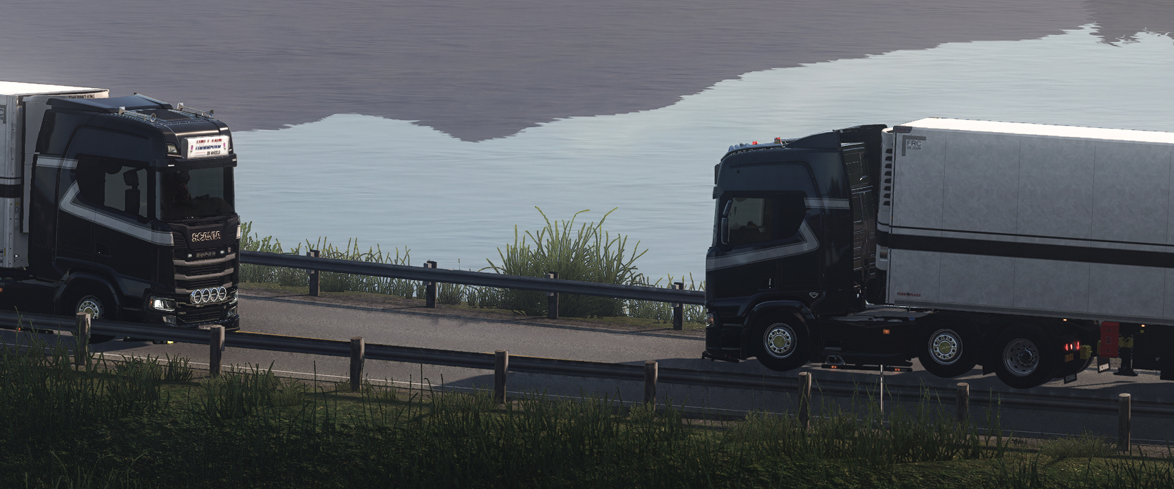A ThermoExpress convoy passing a misty lake at dusk